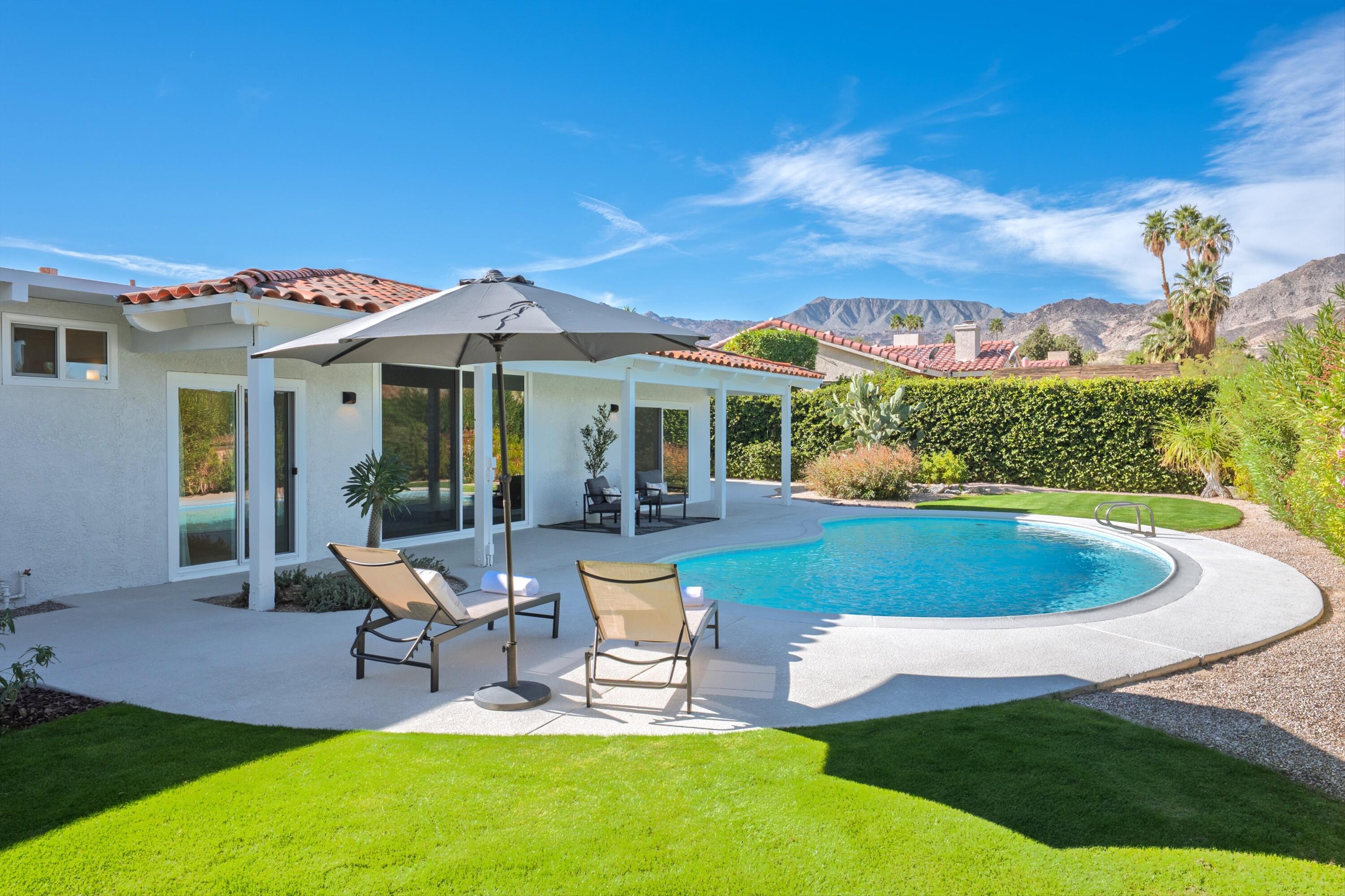 72920 Somera Road Palm Desert, CA 92260 - Photo 3 of 49 a view of a house with backyard porch and patio