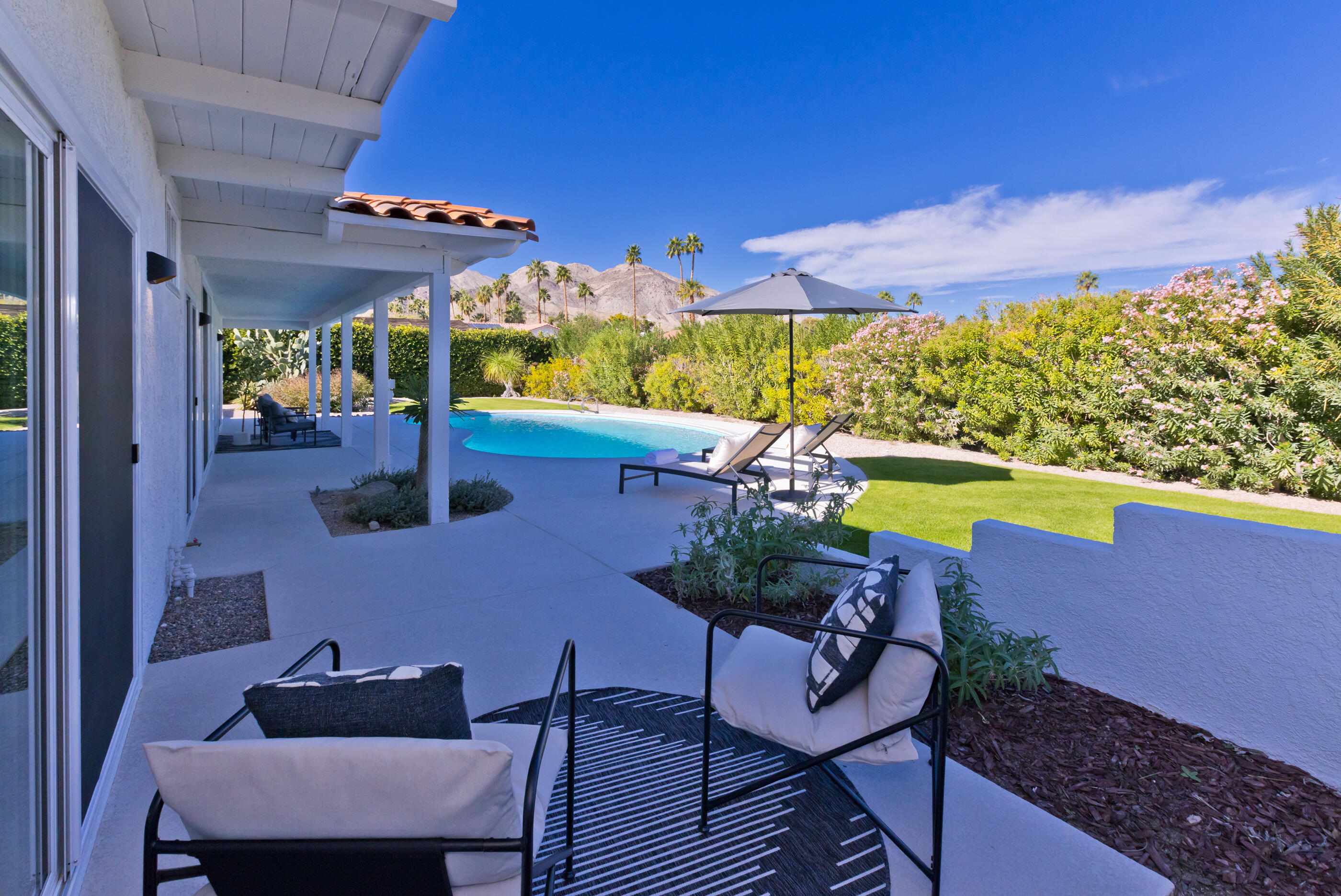 72920 Somera Road Palm Desert, CA 92260 - Photo 40 of 49 a view of a chairs and table in patio with a fire pit