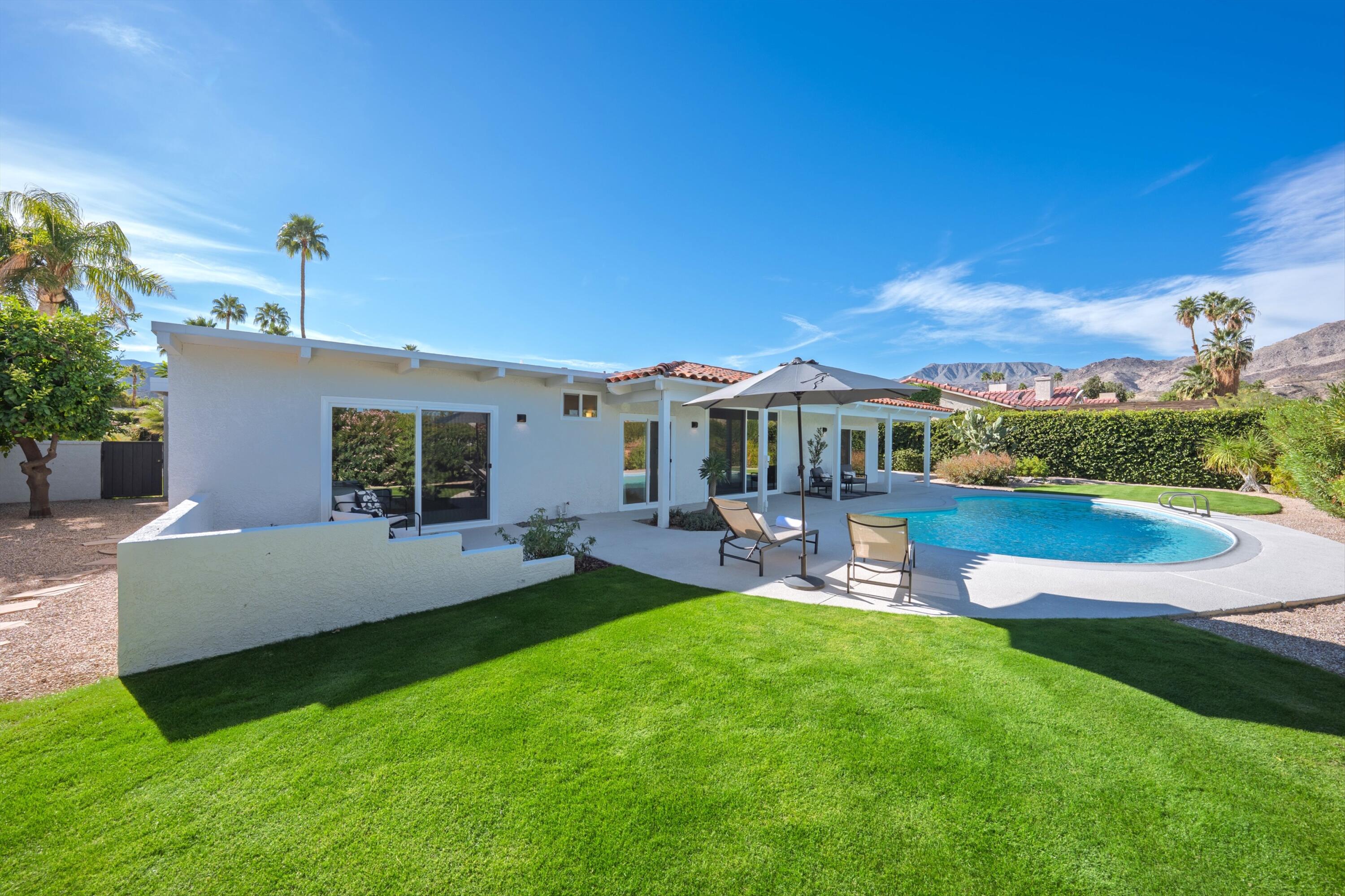 72920 Somera Road Palm Desert, CA 92260 - Photo 46 of 49 a view of a house with a yard porch and sitting area