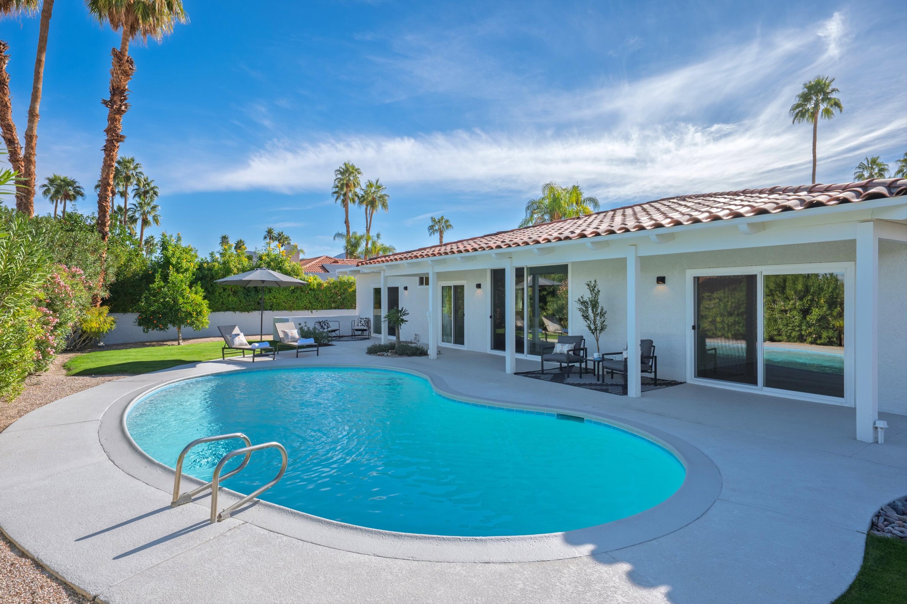 72920 Somera Road Palm Desert, CA 92260 - Photo 47 of 49 a view of a house with swimming pool and sitting area