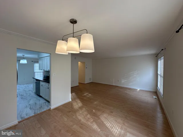 a view of a kitchen counter space and wooden floor