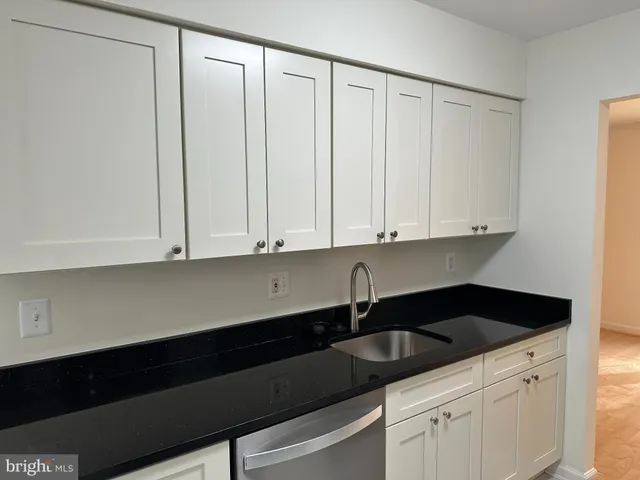 a kitchen with a sink and cabinets