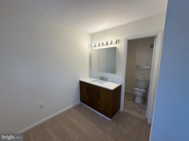 a view of bathroom with a sink and mirror
