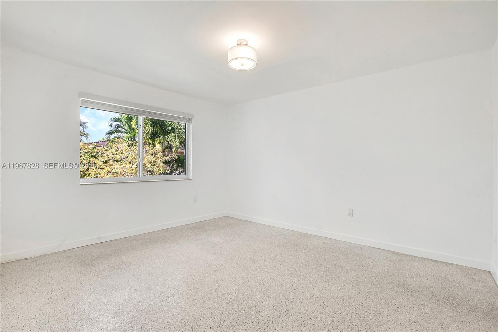 9372 Abbott Avenue Surfside, FL 33154 - Photo 11 of 25 an empty room with a window and a fan