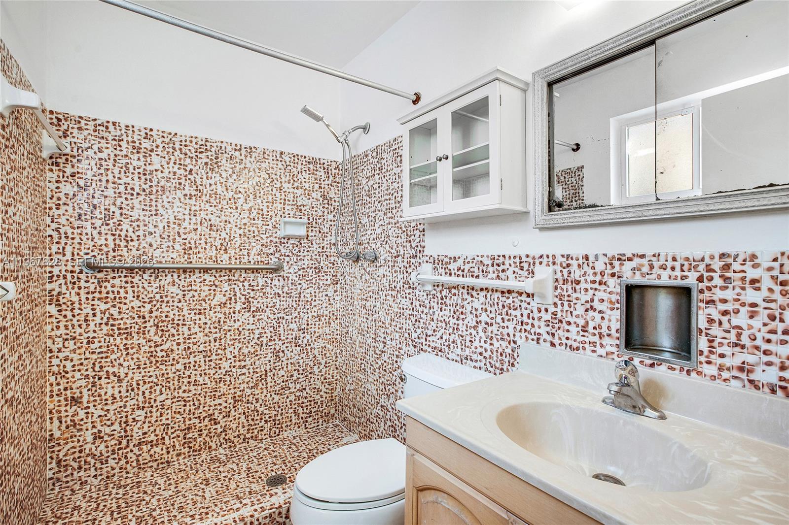 9372 Abbott Avenue Surfside, FL 33154 - Photo 13 of 25 a bathroom with a sink a toilet and shower