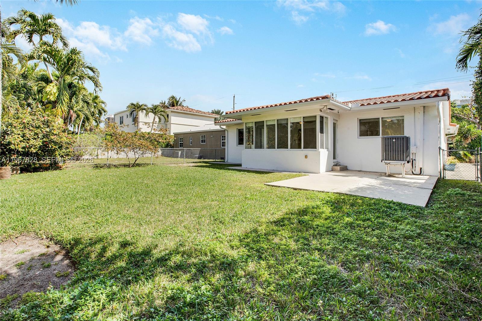9372 Abbott Avenue Surfside, FL 33154 - Photo 19 of 25 a front view of a house with a yard table and chairs