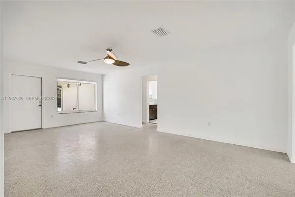 a view of an empty room with a window