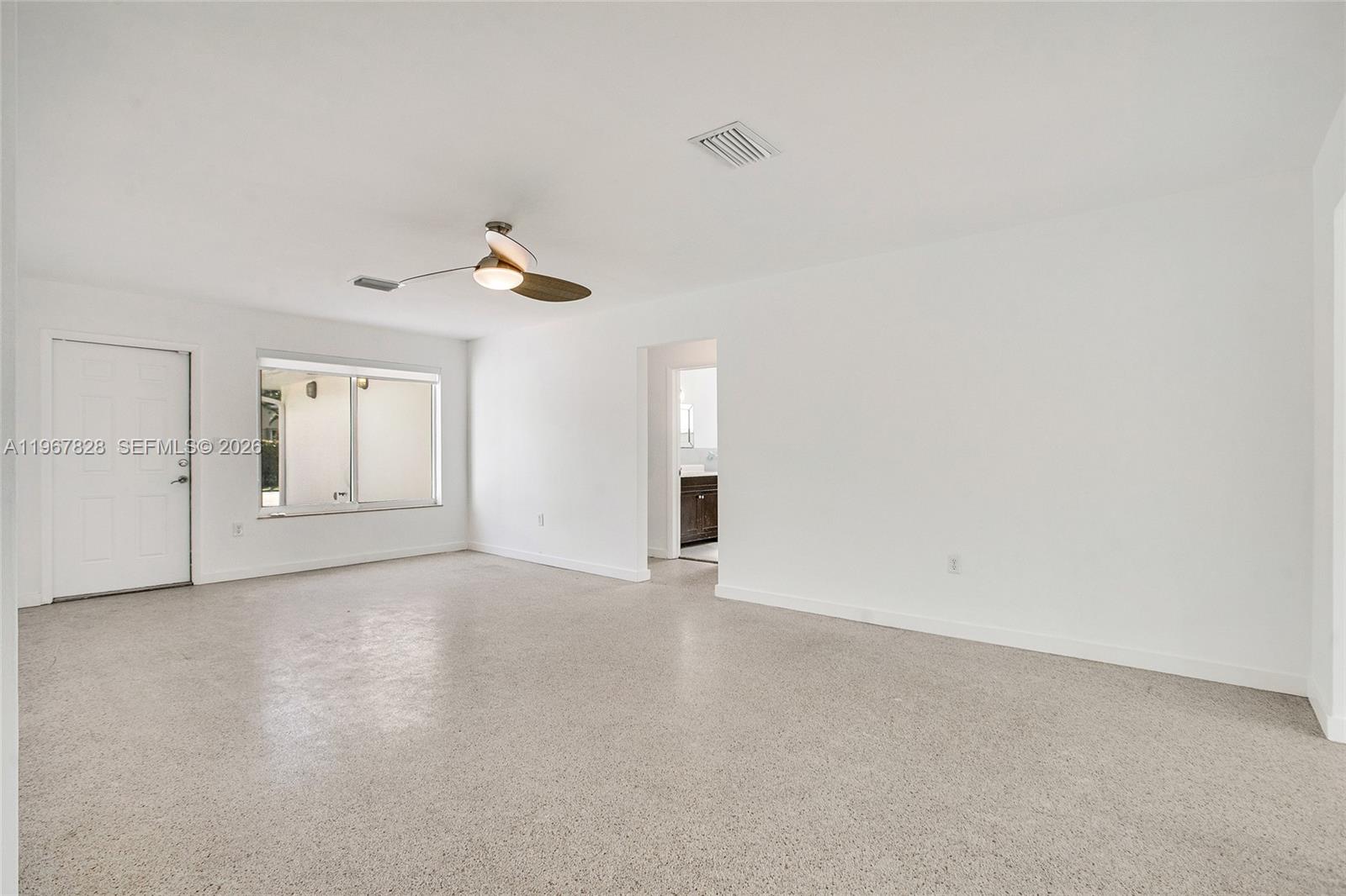 9372 Abbott Avenue Surfside, FL 33154 - Photo 4 of 25 a view of an empty room with chandelier fan and windows