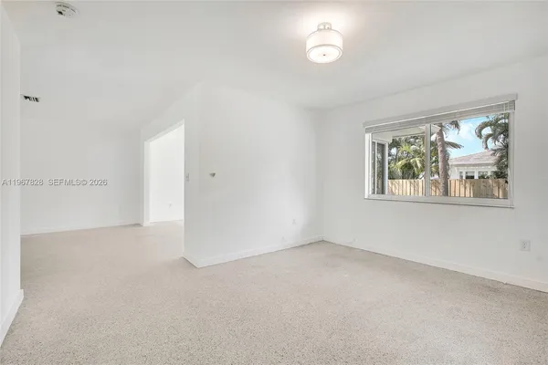 a view of an empty room with a window