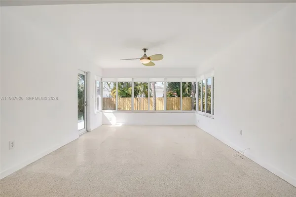 an empty room with windows and closet