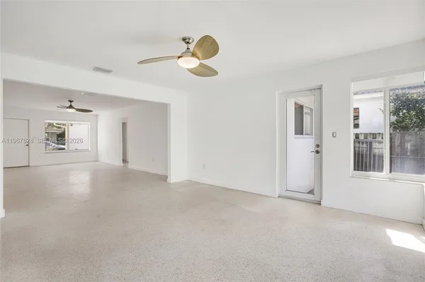 a kitchen with granite countertop a stove top oven microwave and cabinets