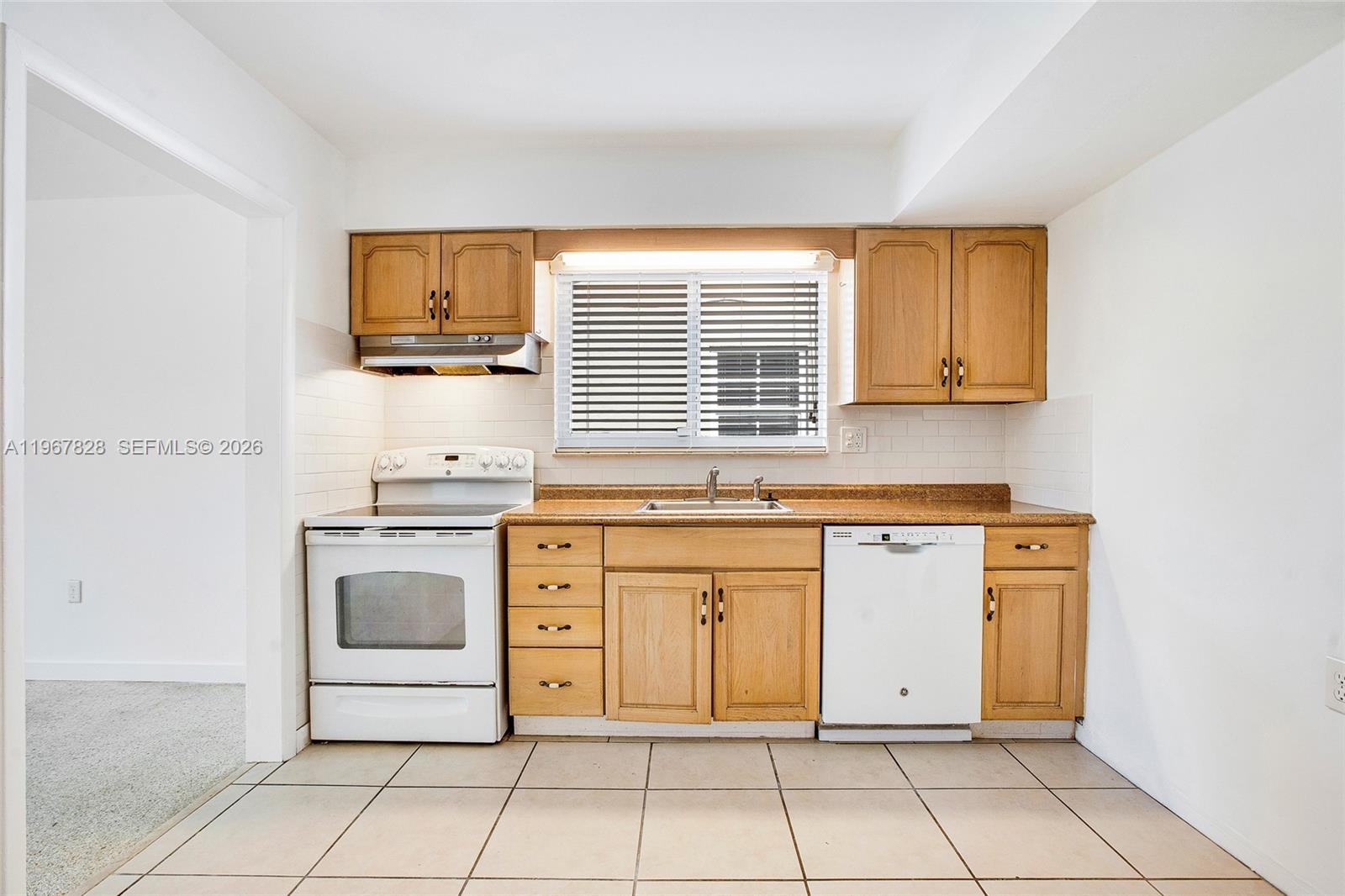 9372 Abbott Avenue Surfside, FL 33154 - Photo 8 of 25 a kitchen with granite countertop a stove top oven microwave and cabinets