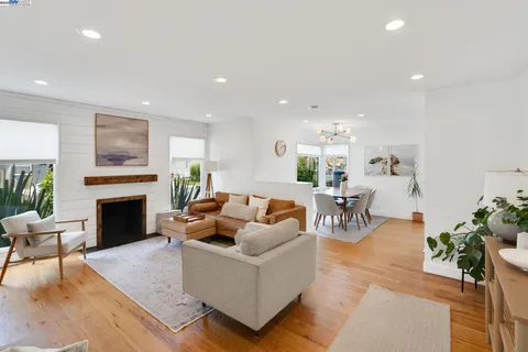a living room with furniture a fireplace and a table