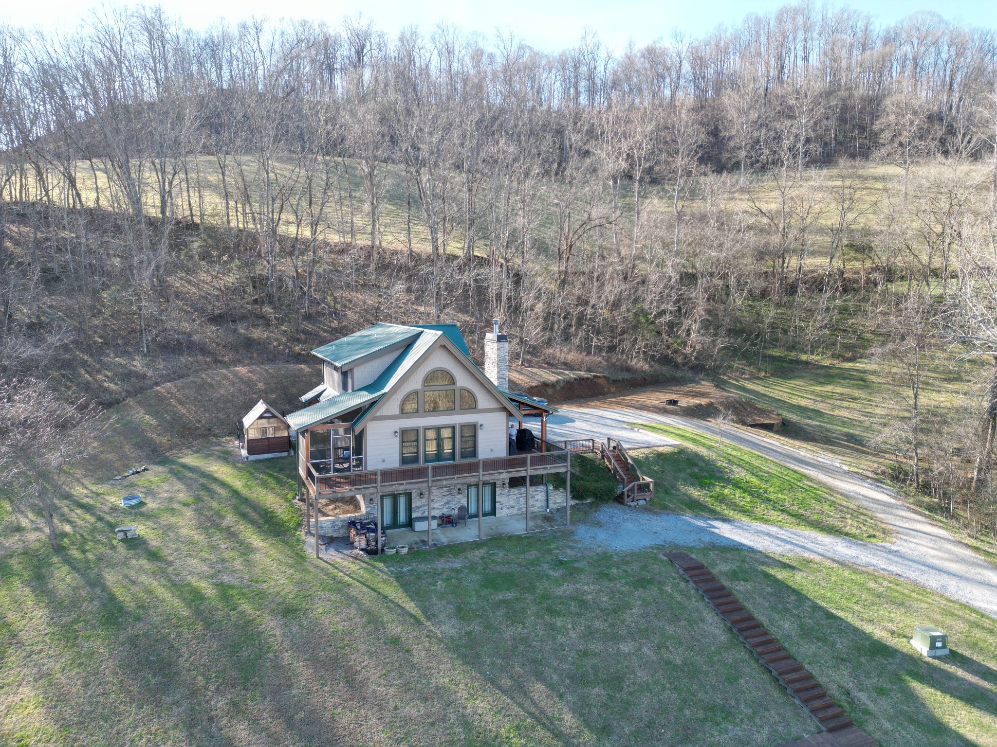 575 East Fork Road Whitleyville, TN 38588 - Photo 22 of 45 a view of a house with a small yard and wooden fence