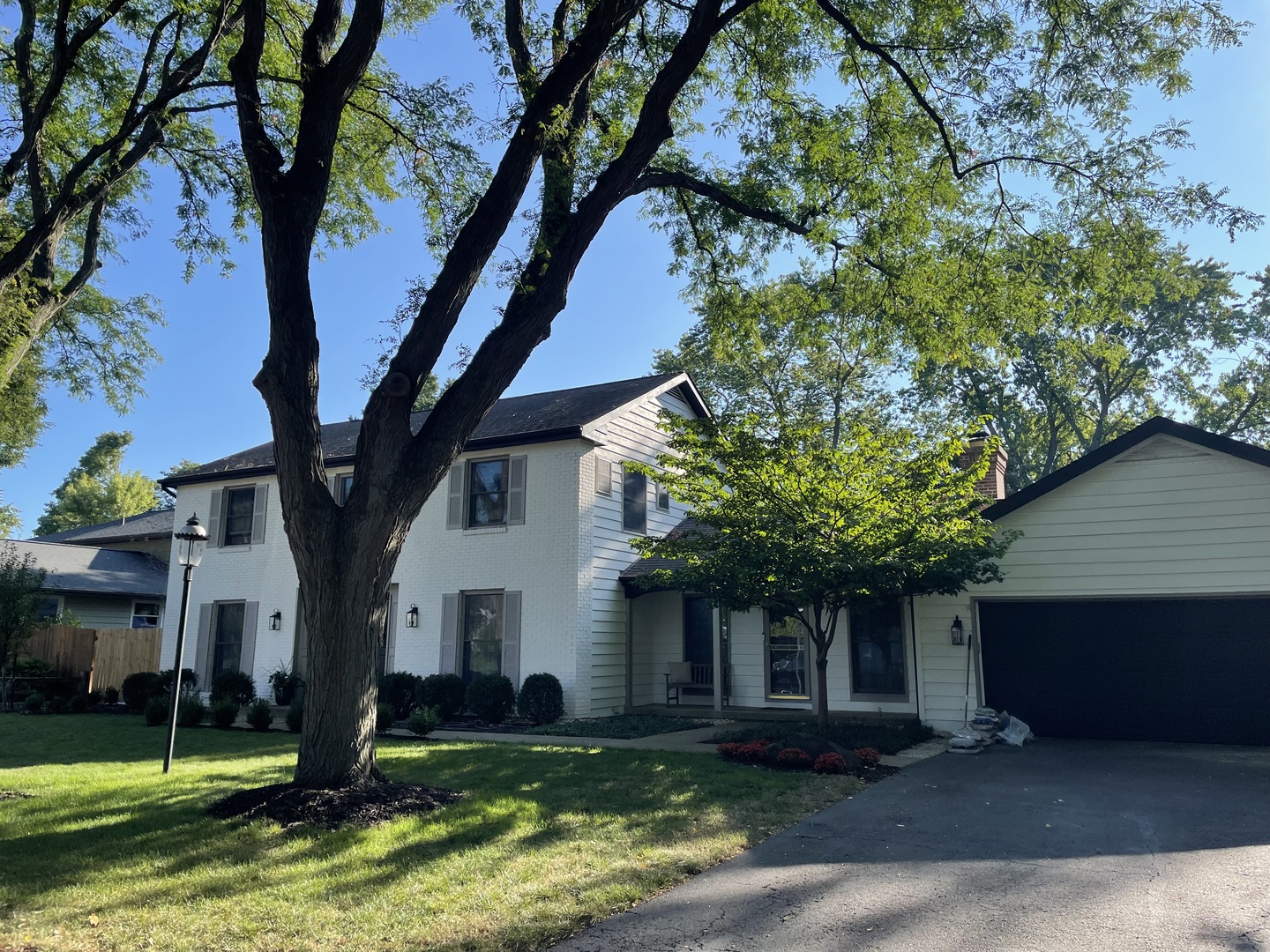 Undisclosed Address Geneva, IL 60134 - Photo 2 of 10 a front view of a house with a yard and large trees