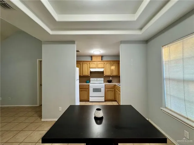 a kitchen with a sink cabinets stainless steel appliances and a window