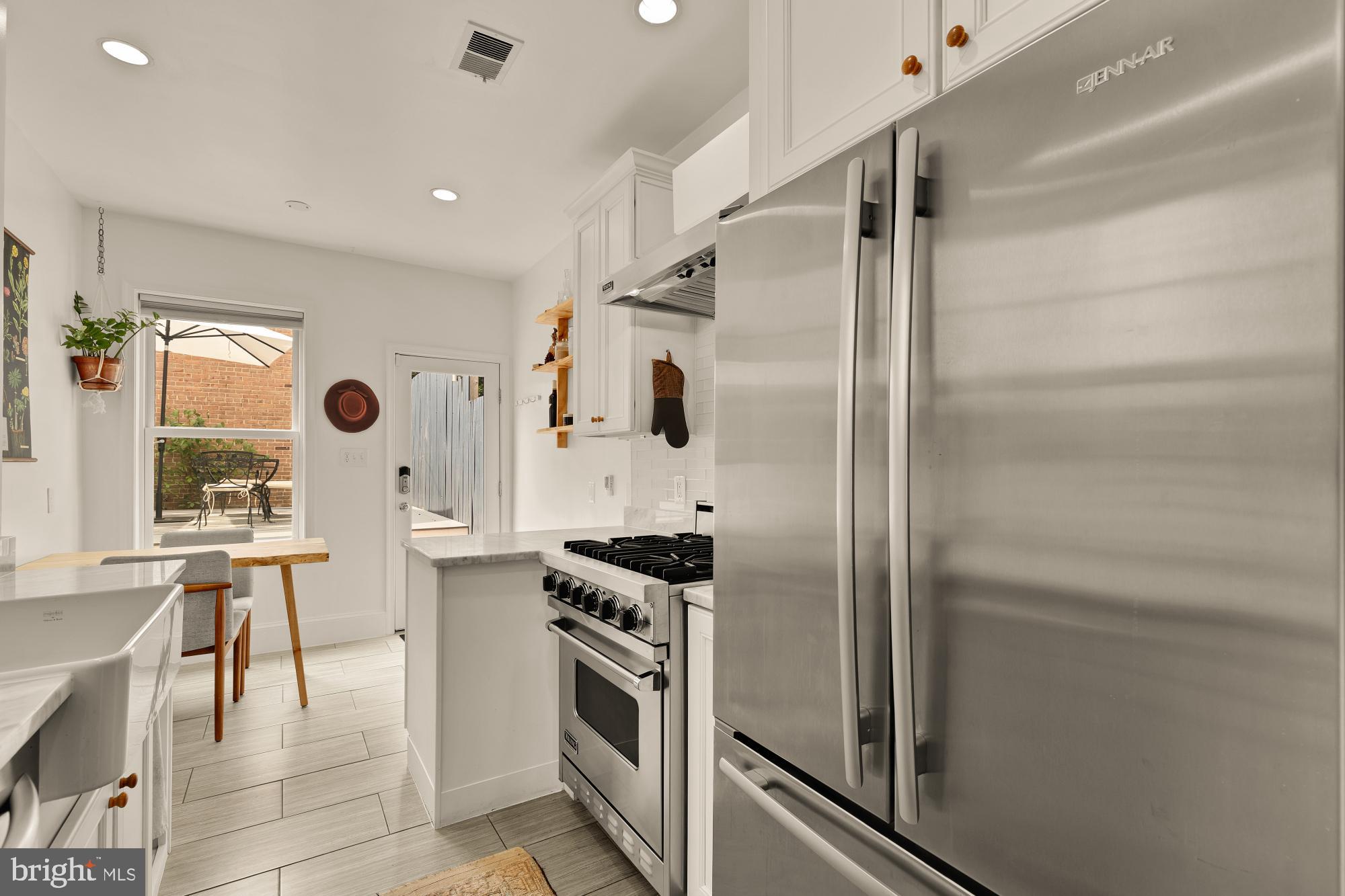 1338 28th Street Northwest Washington, DC 20007 - Photo 15 of 39 a kitchen with granite countertop a refrigerator and a stove