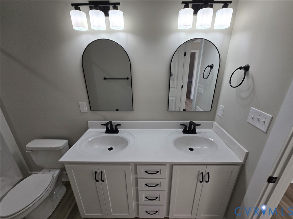1781 Bumpass Road Bumpass, VA 23024 - Photo 21 of 26 a bathroom with a sink and a mirror