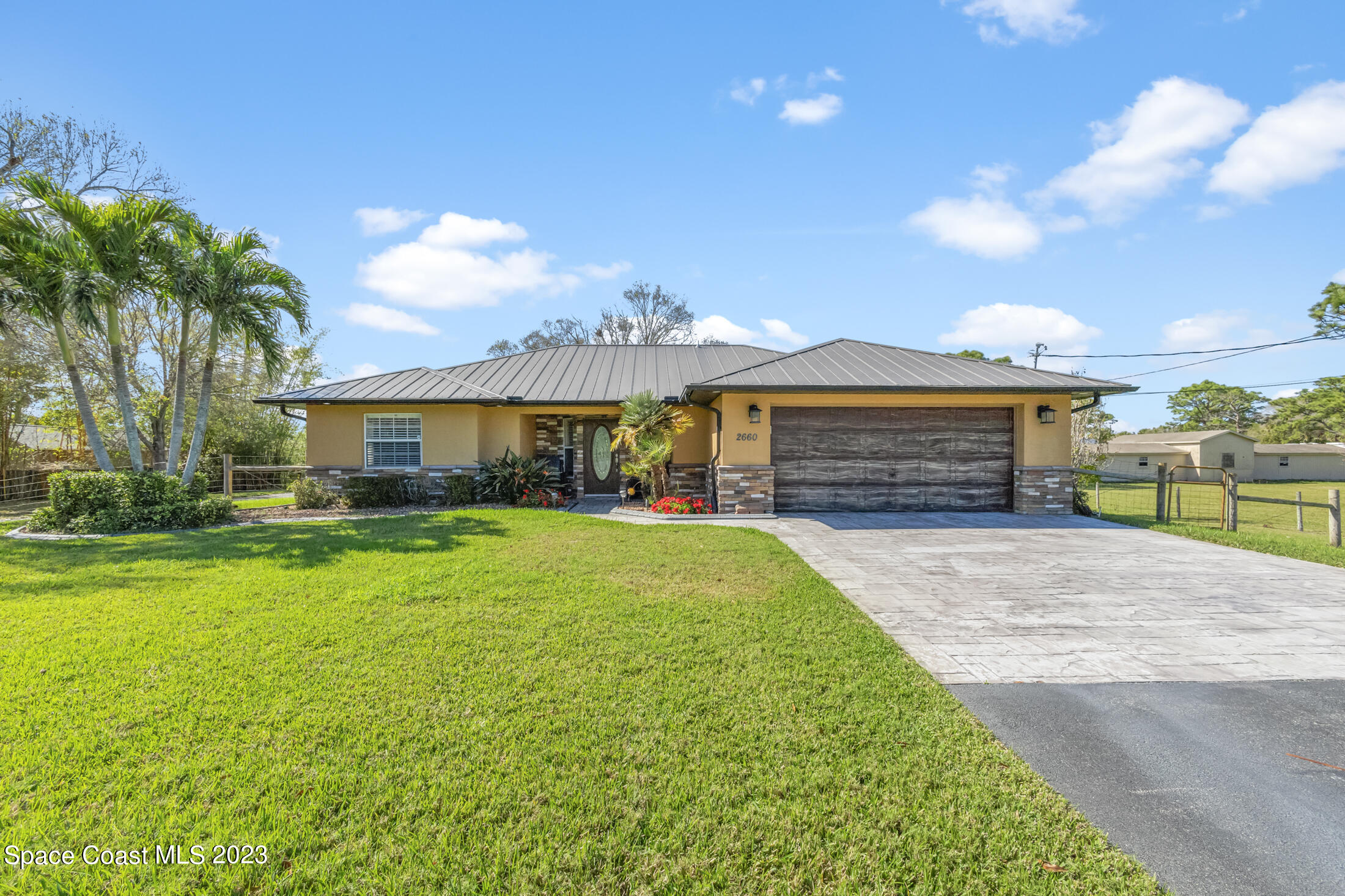 2660 Corey Road Malabar, FL 32950 - Photo 8 of 50 a front view of a house with a garden and yard
