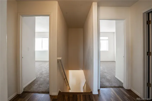 a view of a hallway with wooden floor and glass door
