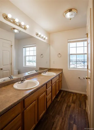 a bathroom with a granite countertop sink a large mirror and a