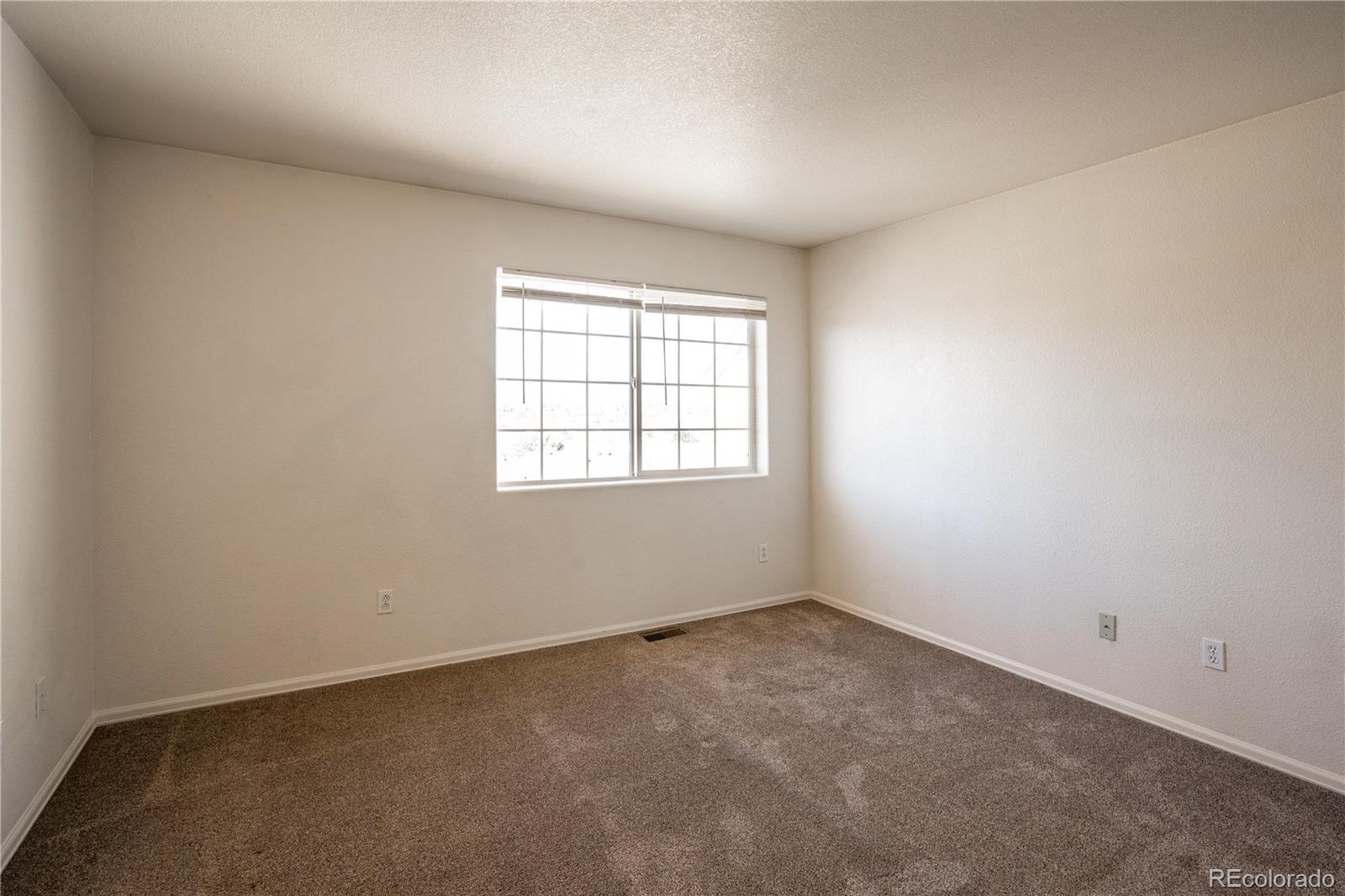 672 Bosque Vista Point, Unit 26 Colorado Springs, CO 80916 - Photo 17 of 25 an empty room with a window