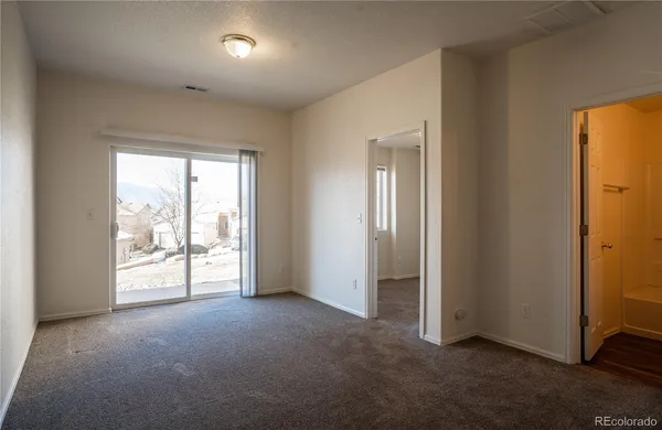 an empty room with windows and closet