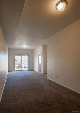 an empty room with windows and yard