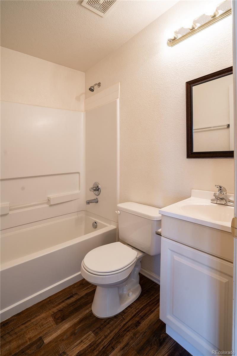 672 Bosque Vista Point, Unit 26 Colorado Springs, CO 80916 - Photo 24 of 25 a bathroom with a toilet a sink and a bathtub