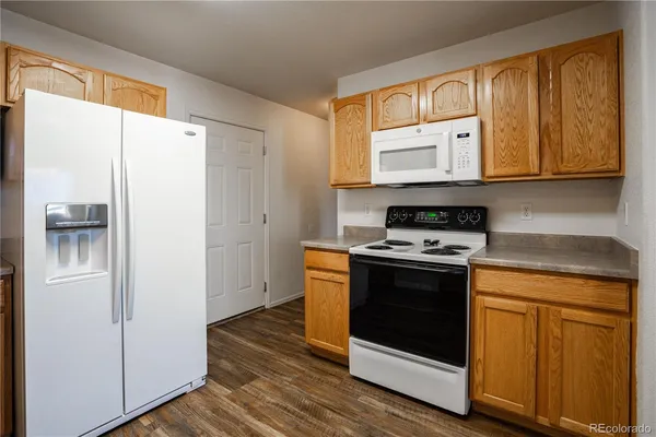 a kitchen with stainless steel appliances granite countertop a stove a refrigerator and a cabinets