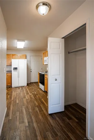 a view of kitchen with refrigerator and window