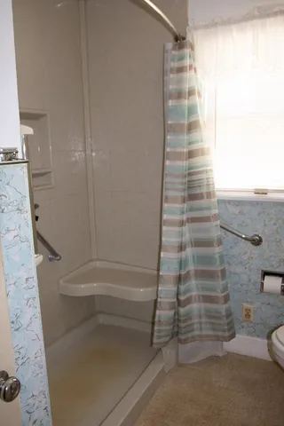 a white toilet sitting next to a bathroom sink
