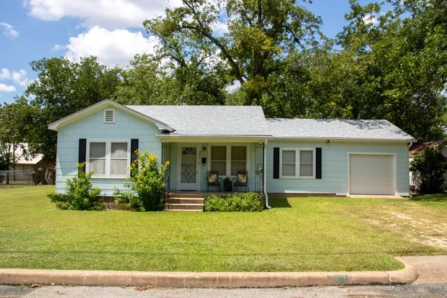 a front view of a house with garden