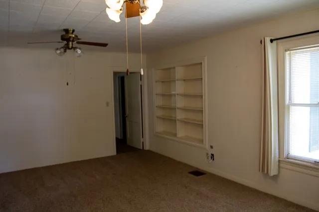 an empty room with a empty space and a window