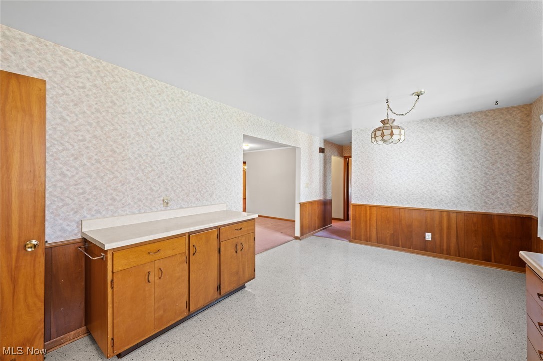 586 Bishop Road Cleveland, OH 44143 - Photo 8 of 24 Kitchen with wallpapered walls, light countertops, and wainscoting