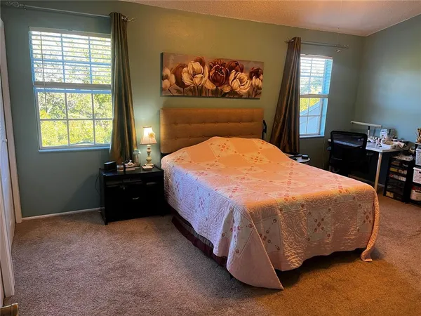 a bed sitting in a bedroom next to a window