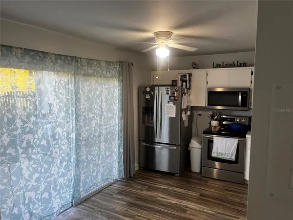 a metallic refrigerator freezer sitting in a kitchen