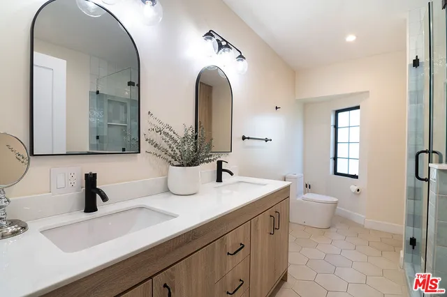 a bathroom with a double vanity sink and a mirror