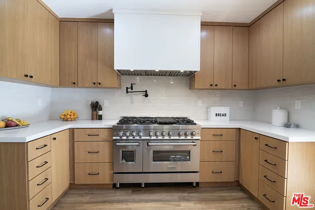 a kitchen with cabinets appliances and a sink