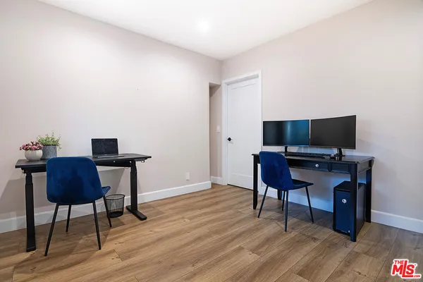 a workspace with furniture and wooden floor