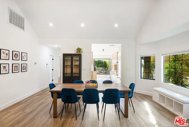 a dining room with furniture and wooden floor