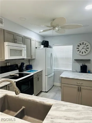 a kitchen with a stove sink and cabinets