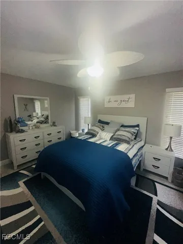 a bedroom with a bed and a view of kitchen