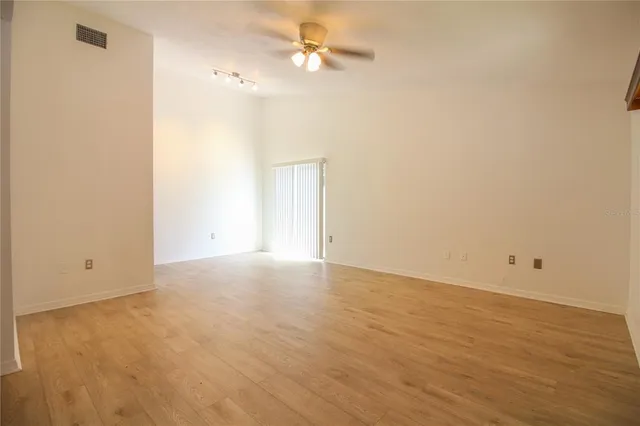a view of an empty room with a ceiling fan