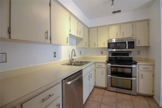 a kitchen with a sink and a stove top oven