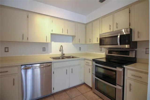 a kitchen with a sink stove and microwave