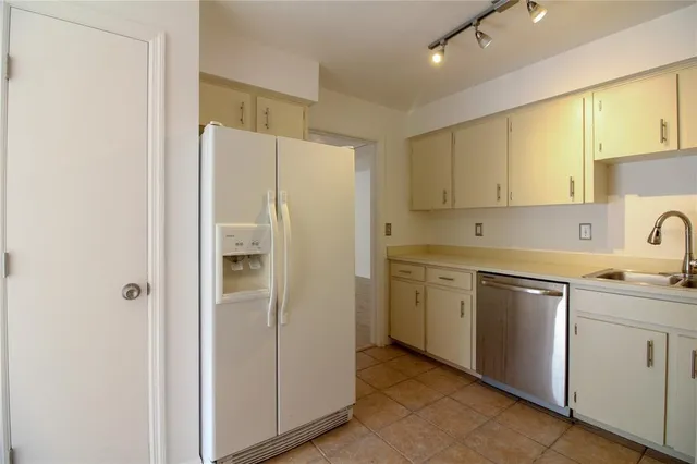 a white refrigerator freezer sitting inside of a kitchen