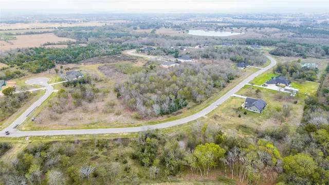 a view of a dry yard with wooden fence