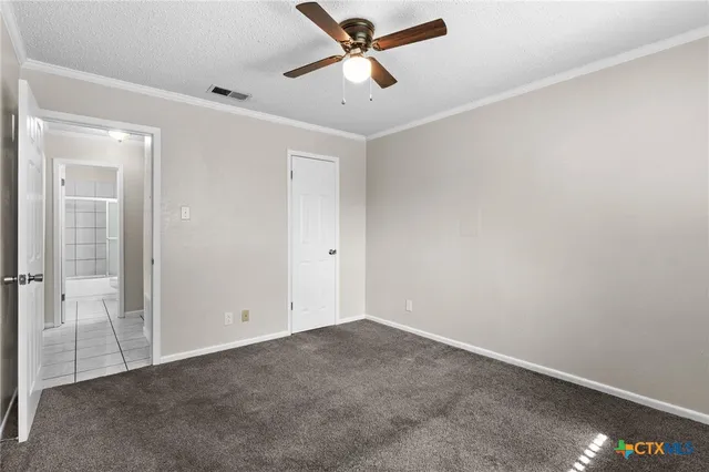 an empty room with closet and windows