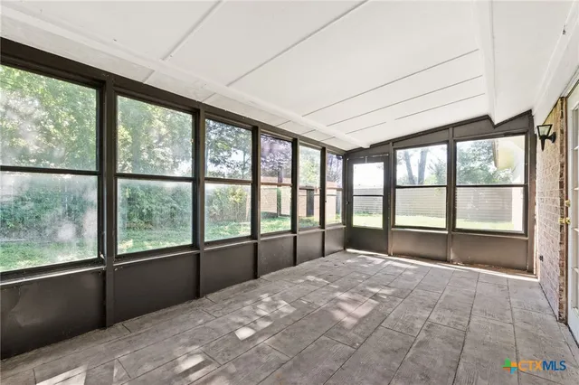 a bedroom with a large bed and a large window